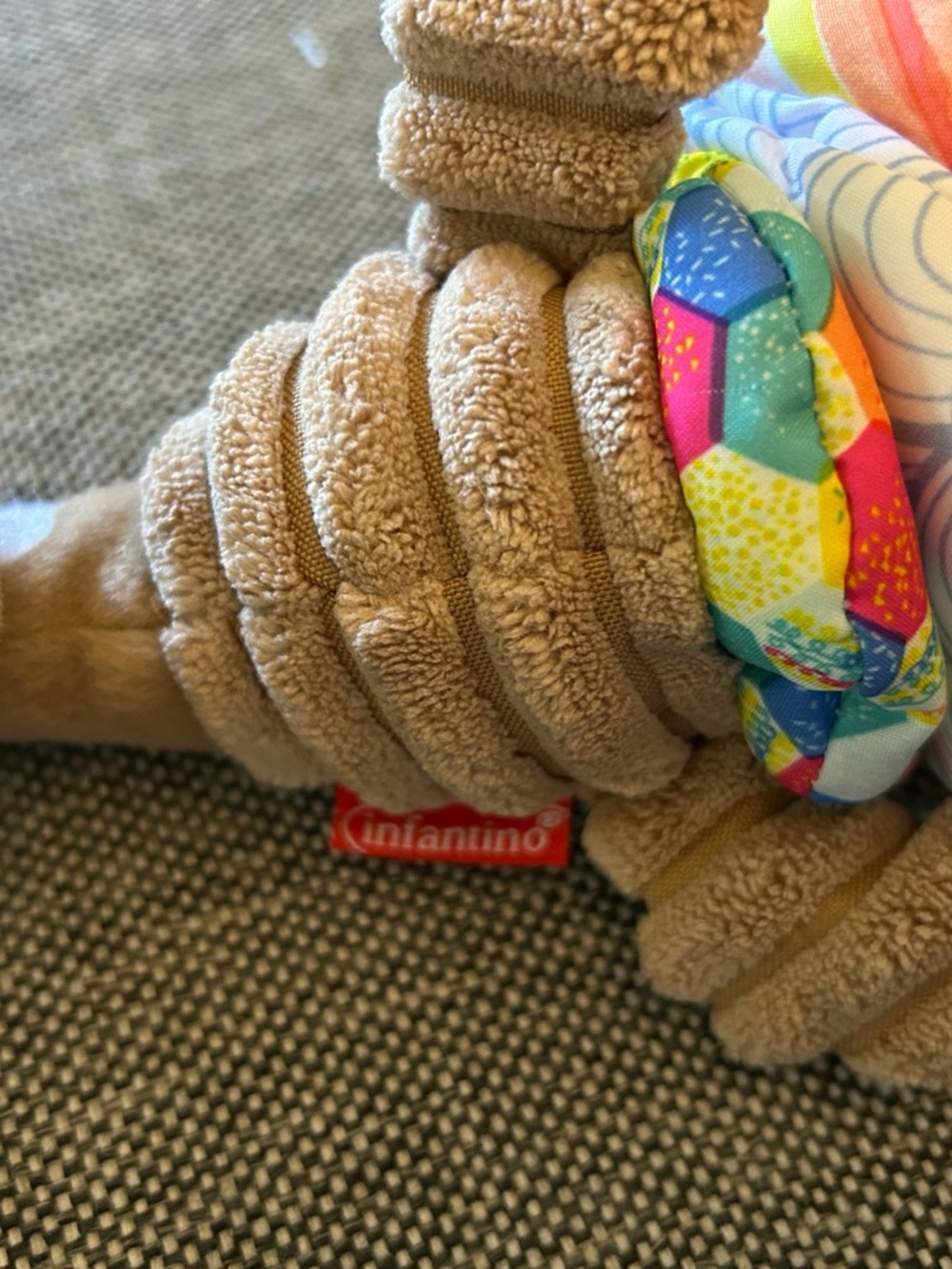 Infantino Tan Plush Baby Toy with Colorful Patterned Ring musical